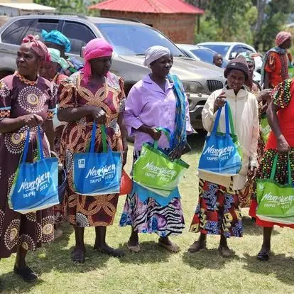 Women carrying gift bags at a BintiCare Forgotten People outreach