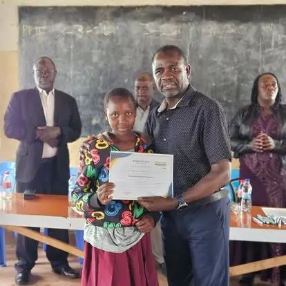 A scholarship student receiving her certificate