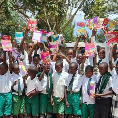 Students holding up their new learning materials
