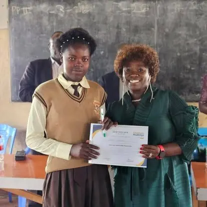 A scholarship student receiving her certificate