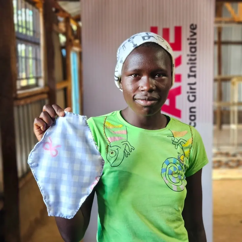 Lilian, a secondary school student in West Pokot, Kenya, holding a reusable sanitary pad