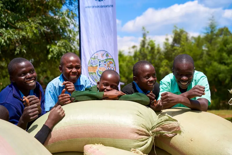 Students with sacks of Lishe Mix ingredients delivered to their school