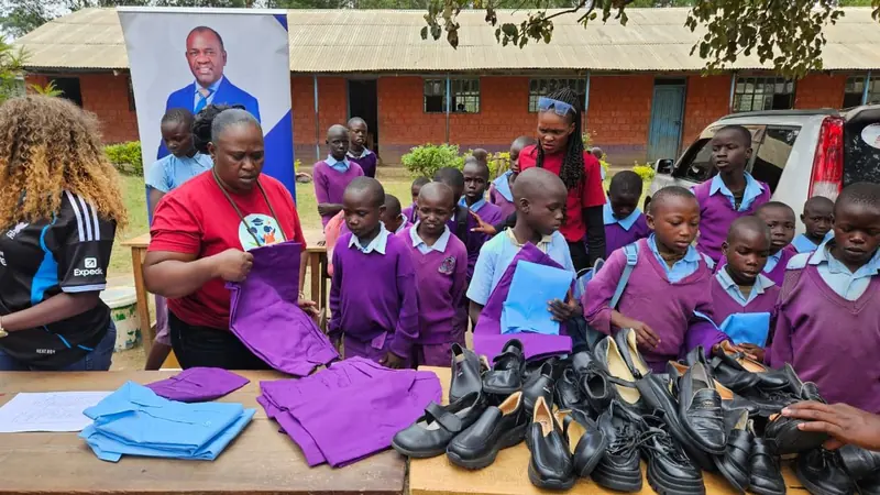 A volunteer folding new uniform shirts for distribution